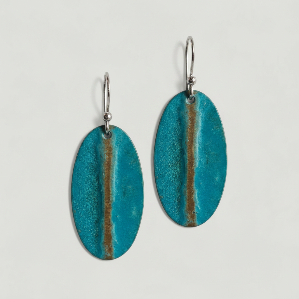Turquoise disc earrings on a light gray background