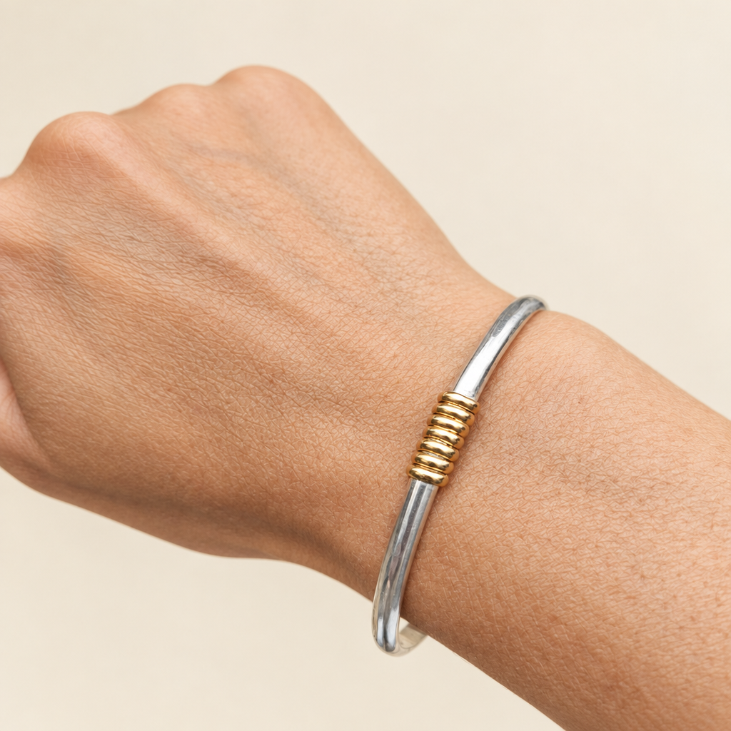 One Meridian bracelet worn on a wrist against an ivory studio background
